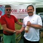 Interim board member Alan Brook with whisky winner Dave Duffield